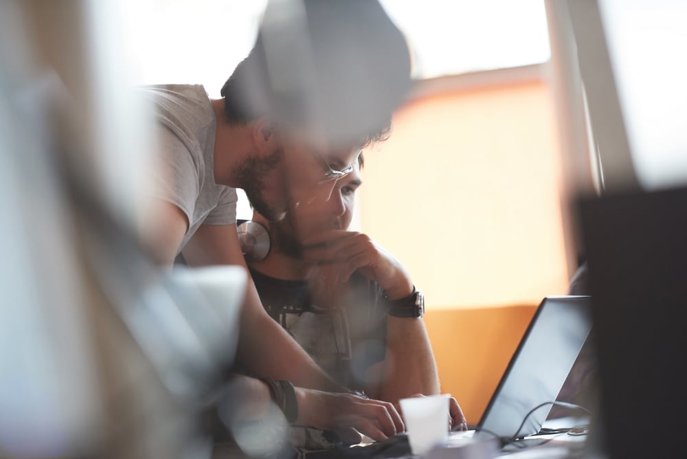 Two people working on an insurance technology project in an office. Two people working on an insurance technology project in an office.